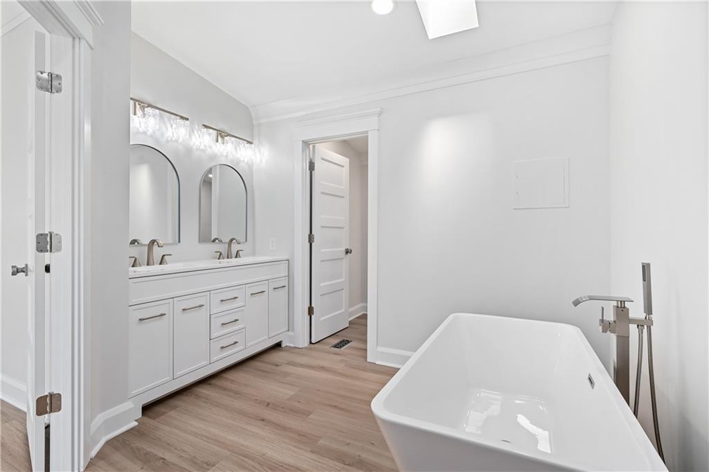 2118 Spooky Hollow Road Lower Burrell, PA 15068 - Photo 20 of 44 a spacious bathroom with a double vanity sink a mirror and a bathtub