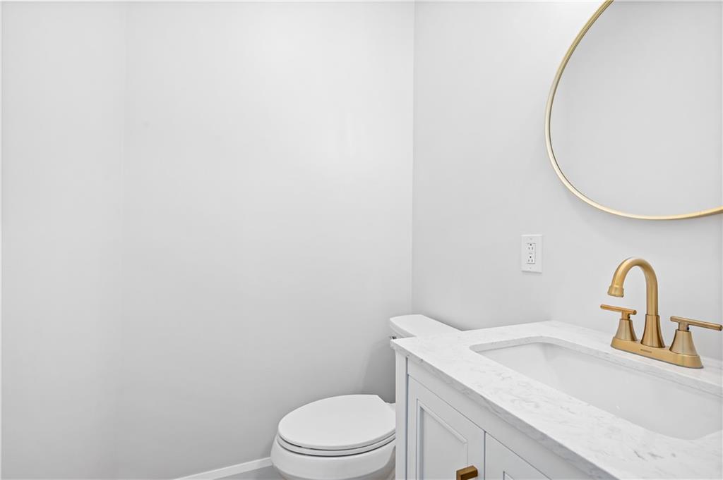 2118 Spooky Hollow Road Lower Burrell, PA 15068 - Photo 28 of 44 a bathroom with a toilet sink and mirror