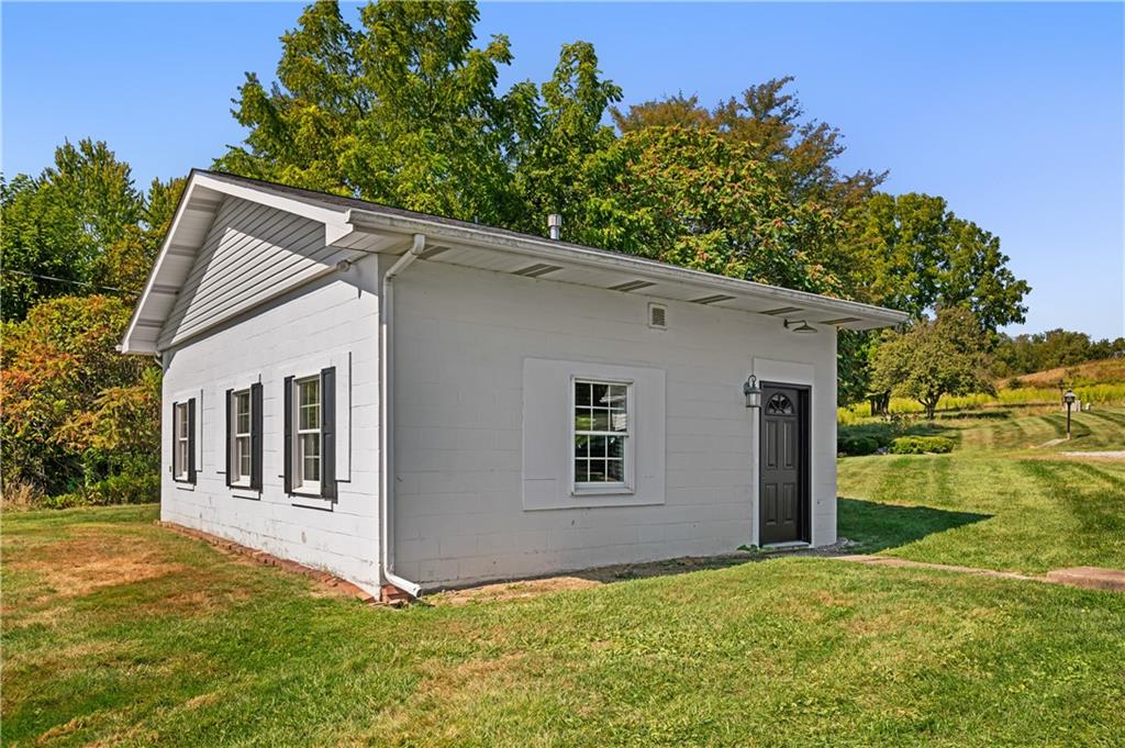 2118 Spooky Hollow Road Lower Burrell, PA 15068 - Photo 38 of 44 a backyard of a house with plants and tree