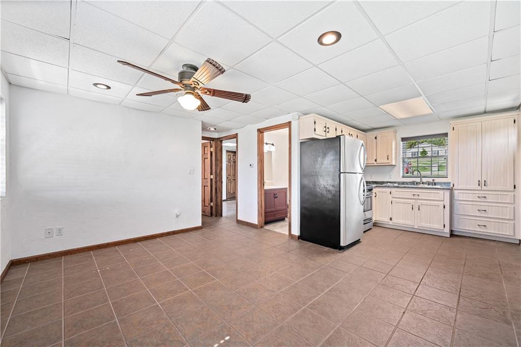 2118 Spooky Hollow Road Lower Burrell, PA 15068 - Photo 40 of 44 a kitchen with kitchen island a counter top space appliances and a ceiling fan