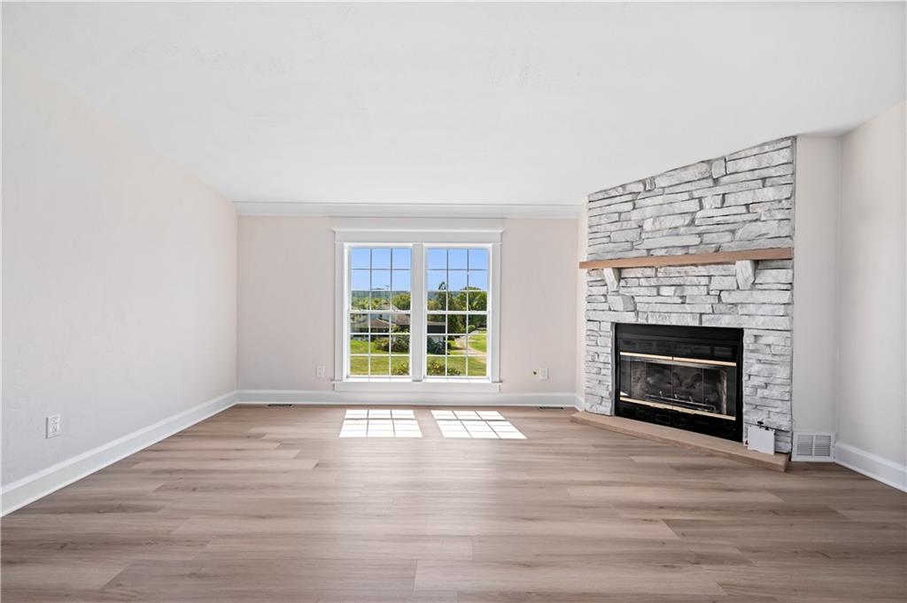 2118 Spooky Hollow Road Lower Burrell, PA 15068 - Photo 10 of 44 an empty room with floor to ceiling window and fireplace