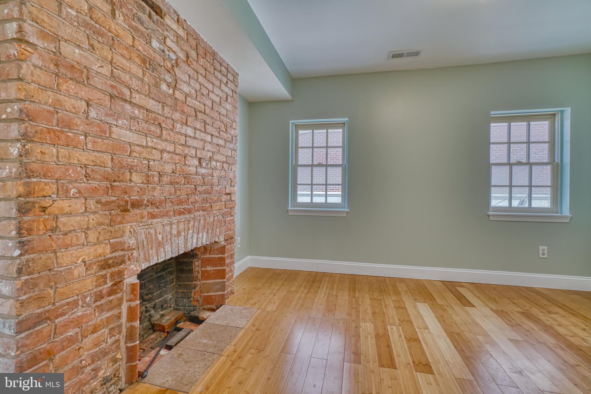 644 Jasper Street Baltimore, MD 21201 - Photo 15 of 27 a view of an empty room with wooden floor and a window