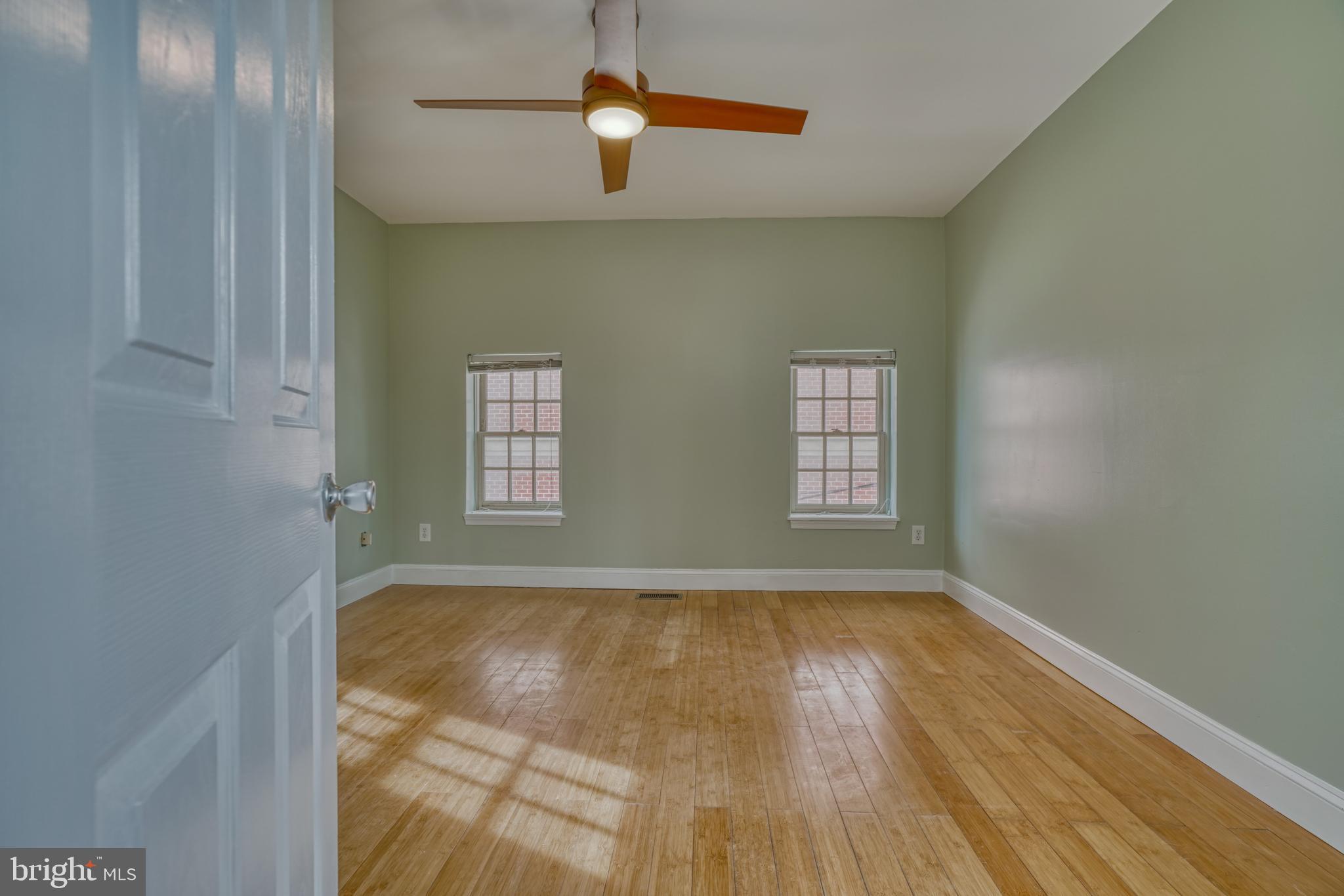 644 Jasper Street Baltimore, MD 21201 - Photo 20 of 27 an empty room with windows and ceiling fan