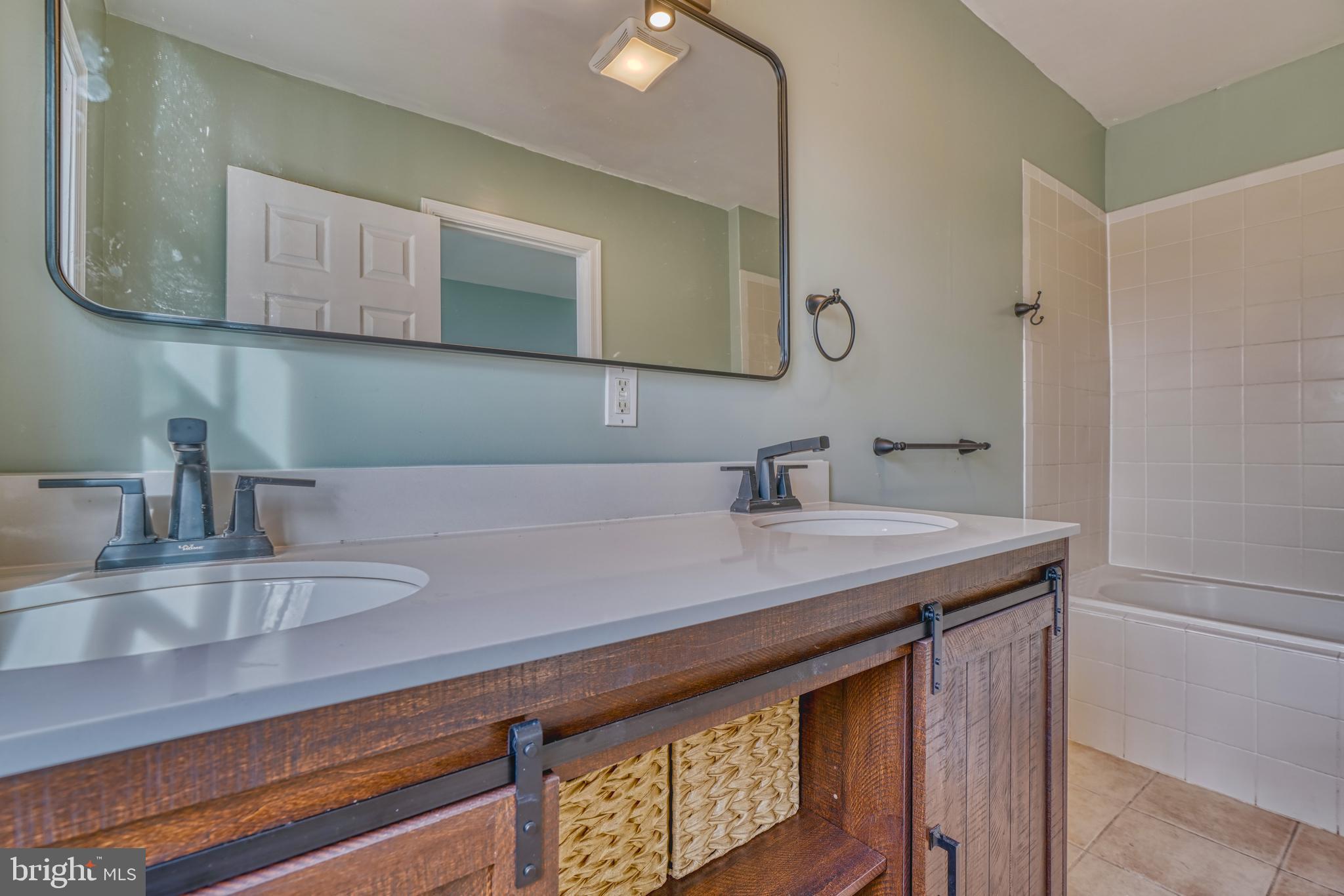 644 Jasper Street Baltimore, MD 21201 - Photo 23 of 27 a bathroom with a sink and a mirror