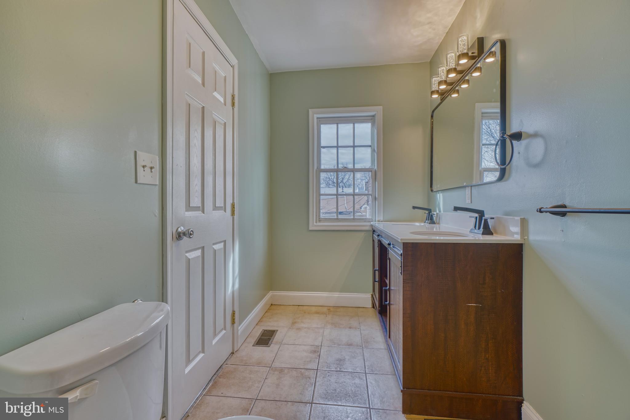 644 Jasper Street Baltimore, MD 21201 - Photo 24 of 27 a bathroom with a sink a toilet and shower