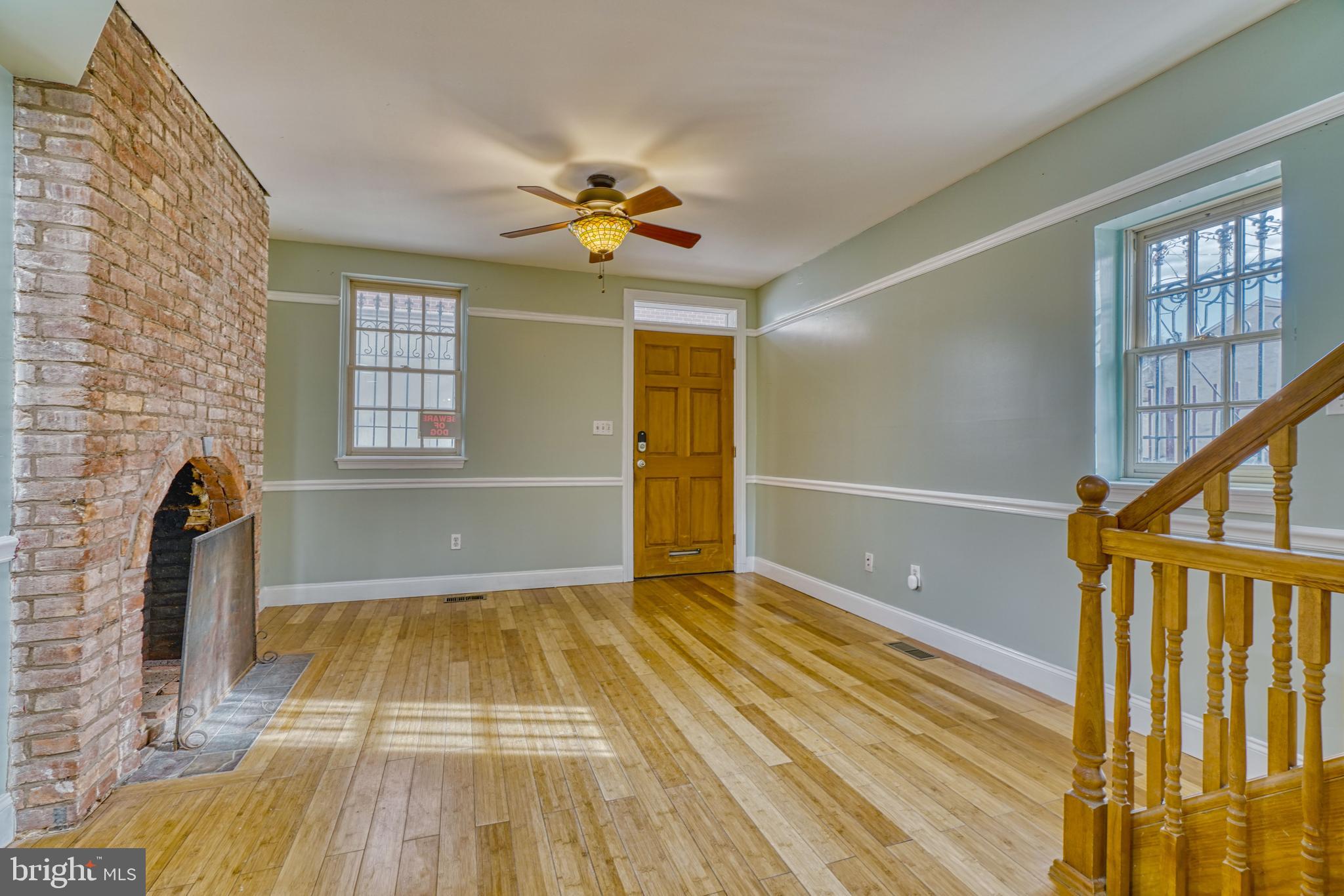 644 Jasper Street Baltimore, MD 21201 - Photo 6 of 27 a view of a livingroom with wooden floor and a ceiling fan