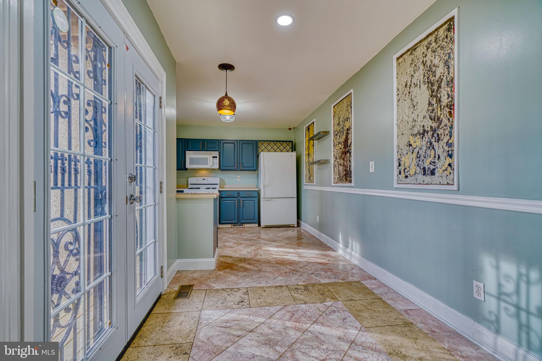 644 Jasper Street Baltimore, MD 21201 - Photo 8 of 27 a view of a hallway with wooden floor and a kitchen