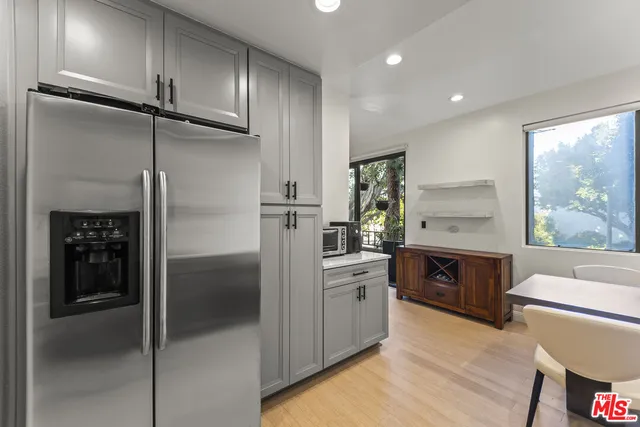 a kitchen with cabinets and stainless steel appliances
