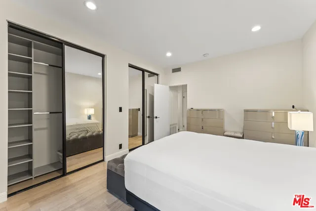 a large white bed in a white room