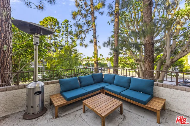 a view of a two chairs in the back yard of the house