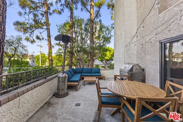 a view of a patio with table and chairs and potted plants