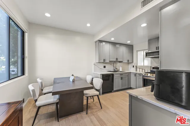 a kitchen with a sink cabinets and stainless steel appliances