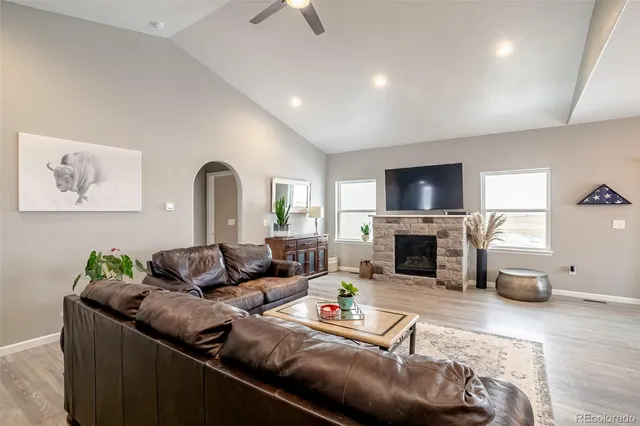 a kitchen with a stove top oven a sink dishwasher a dining table and chairs with wooden floor