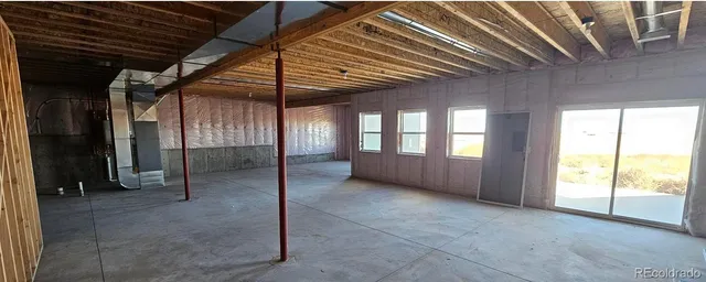 a view of a dirt road and a building in the background