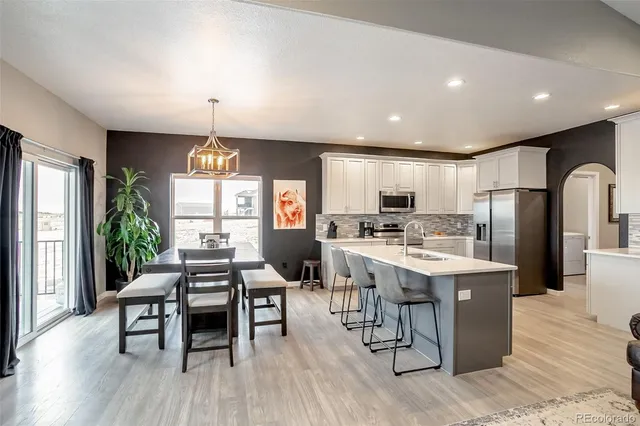 a kitchen with stainless steel appliances kitchen island granite countertop a sink and cabinets