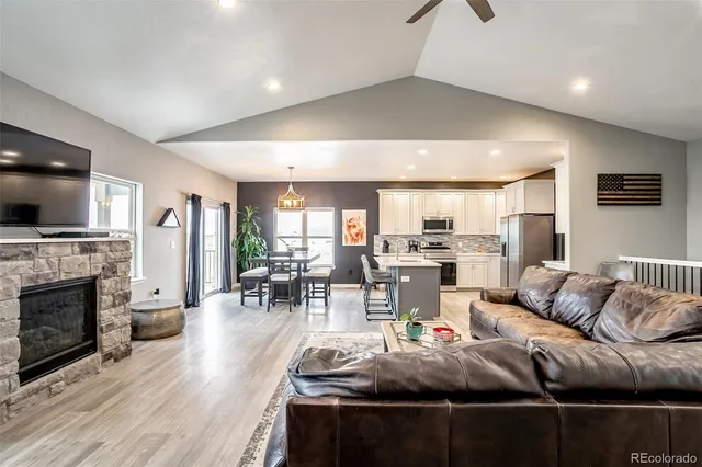 a living room with furniture and a fireplace