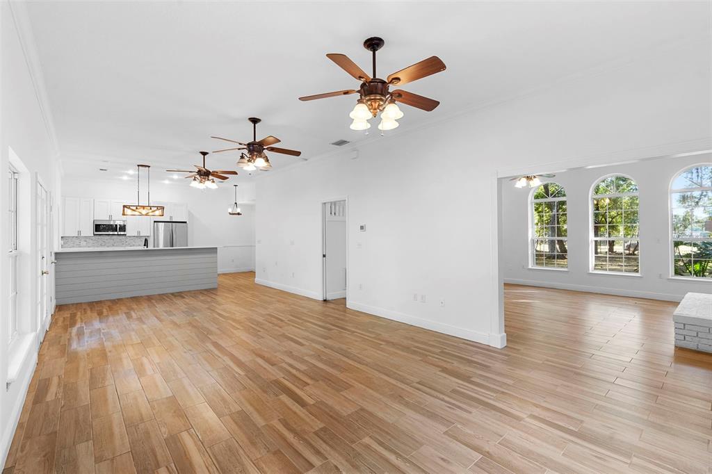 4855 Lillian Black Road St. Cloud, FL 34771 - Photo 18 of 62 a view of a room with wooden floor and a ceiling fan