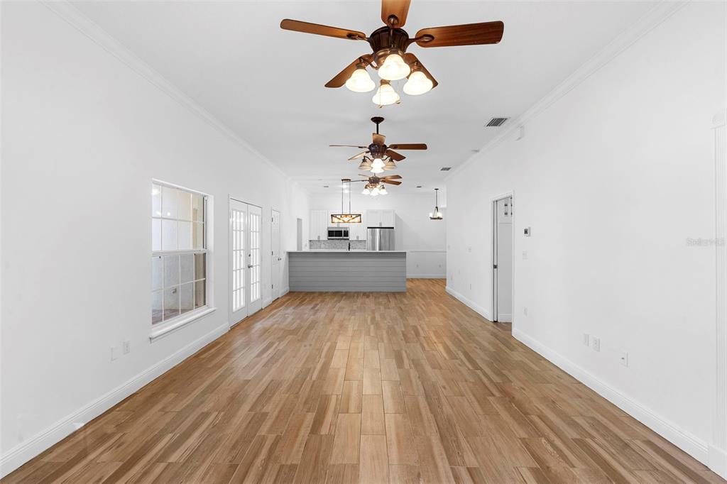 4855 Lillian Black Road St. Cloud, FL 34771 - Photo 19 of 62 a view of a room with wooden floor closet and a chandelier