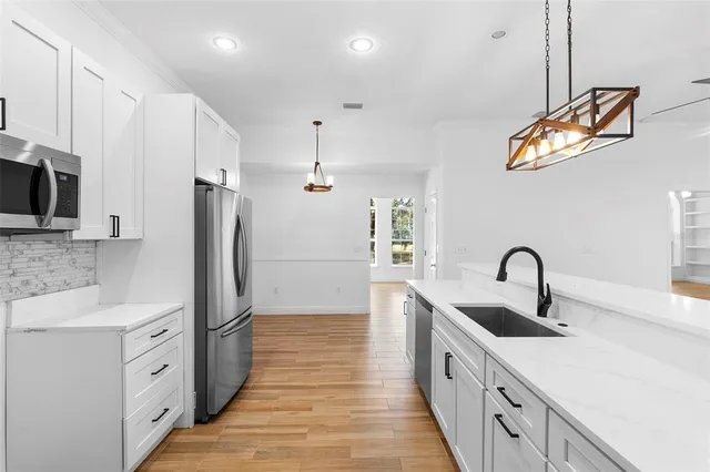 a view of a hallway view with wooden floor and staircase