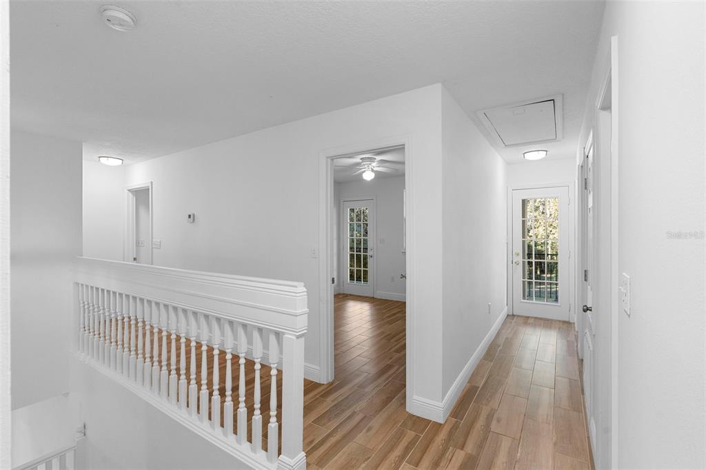 4855 Lillian Black Road St. Cloud, FL 34771 - Photo 30 of 62 a view of a hallway view with wooden floor and staircase