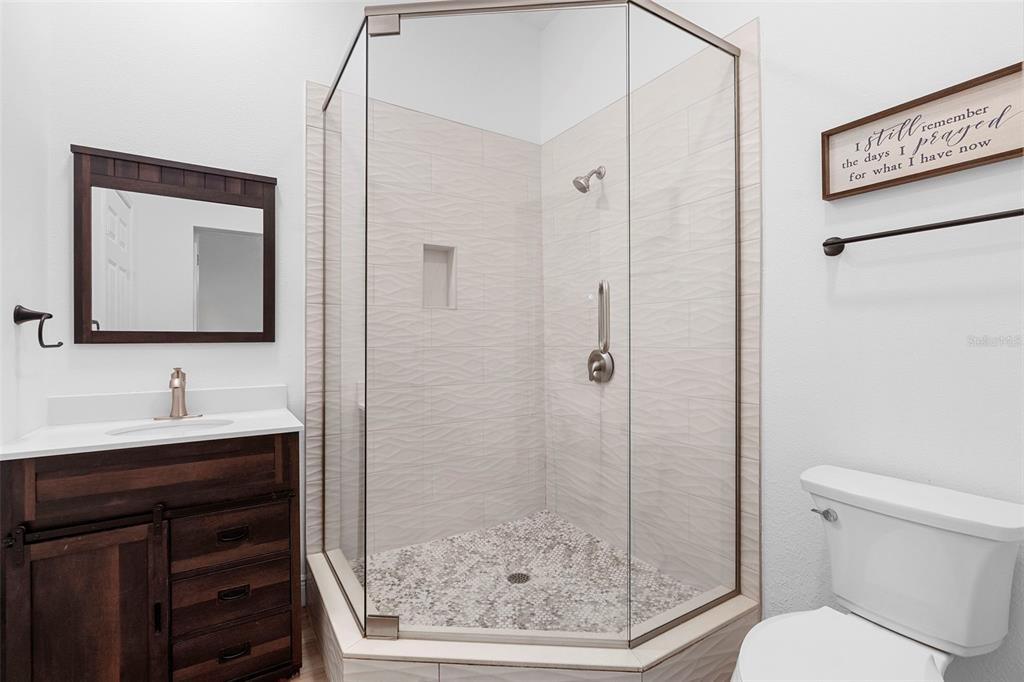 4855 Lillian Black Road St. Cloud, FL 34771 - Photo 32 of 62 a bathroom with a toilet sink and shower