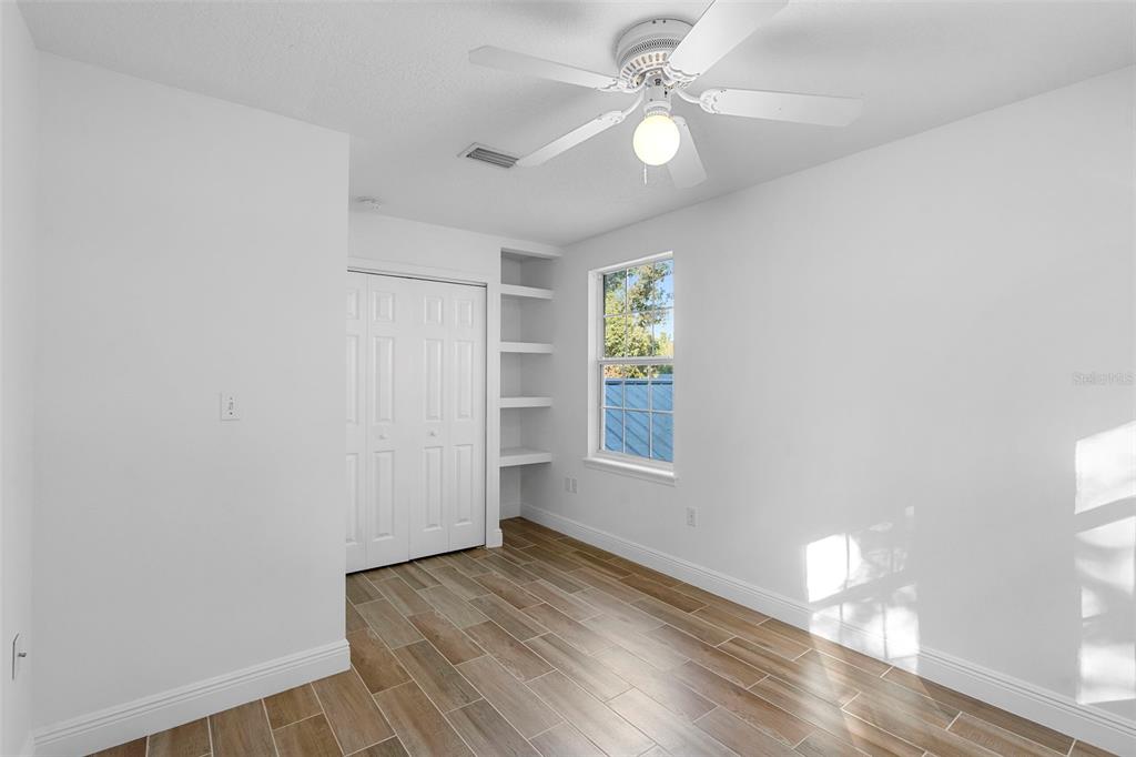 4855 Lillian Black Road St. Cloud, FL 34771 - Photo 33 of 62 wooden floor in an empty room with a window