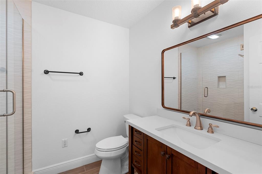 4855 Lillian Black Road St. Cloud, FL 34771 - Photo 36 of 62 a bathroom with a granite countertop sink toilet and mirror