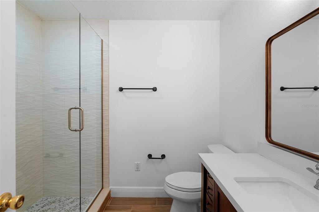 4855 Lillian Black Road St. Cloud, FL 34771 - Photo 37 of 62 a bathroom with a sink a toilet and shower