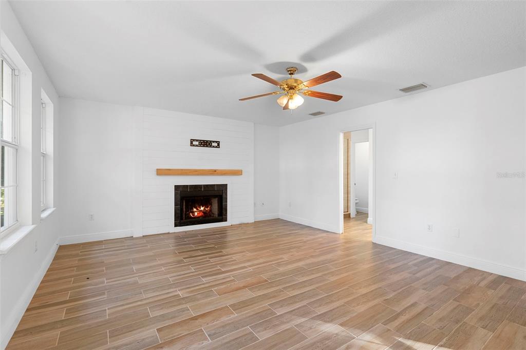 4855 Lillian Black Road St. Cloud, FL 34771 - Photo 38 of 62 a view of an empty room with a fireplace and a window