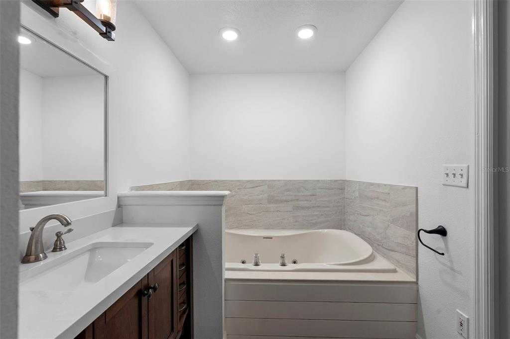 4855 Lillian Black Road St. Cloud, FL 34771 - Photo 41 of 62 a bathroom with a sink and a bathtub