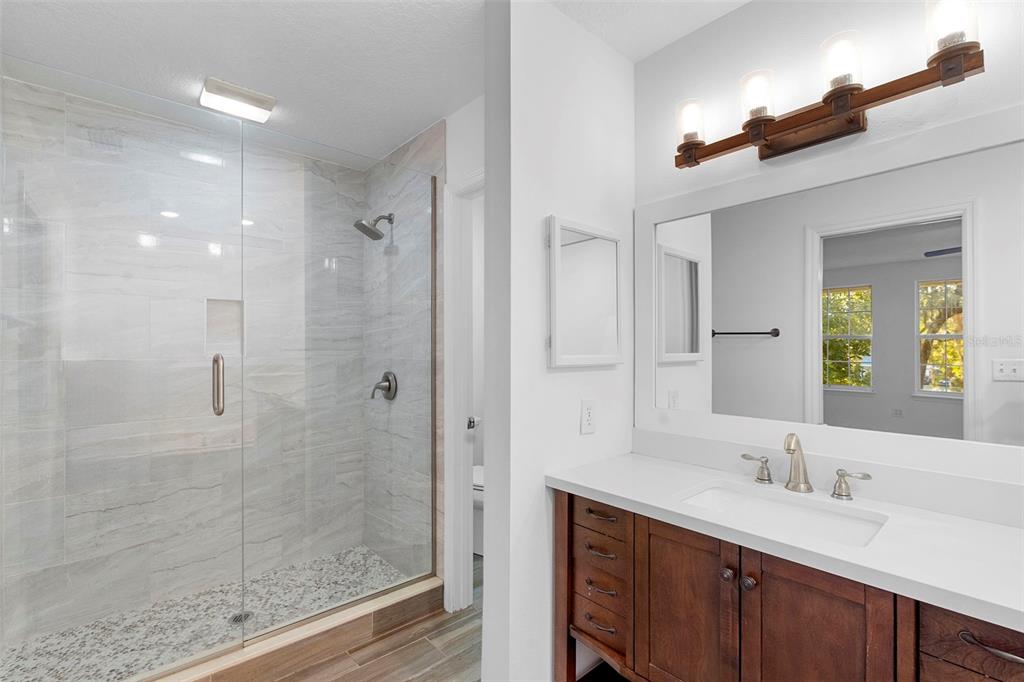 4855 Lillian Black Road St. Cloud, FL 34771 - Photo 42 of 62 a bathroom with a granite countertop sink mirror and double