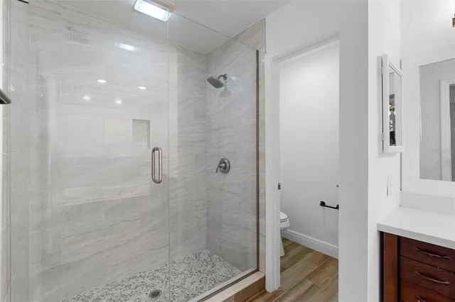 a view of a house with a big yard and large trees