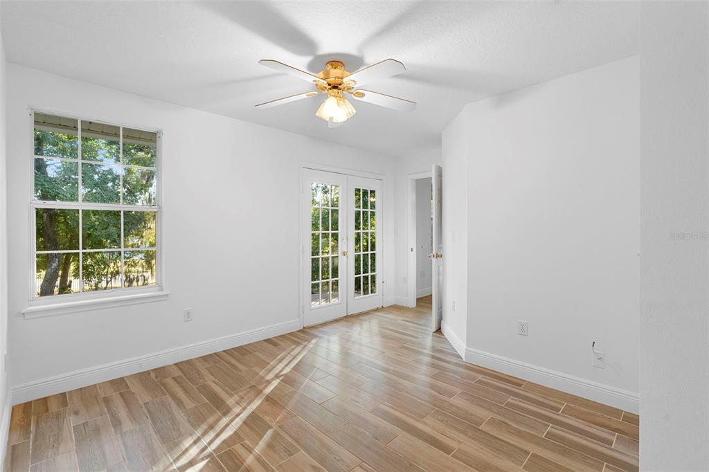 4855 Lillian Black Road St. Cloud, FL 34771 - Photo 44 of 62 an empty room with wooden floor fan and windows