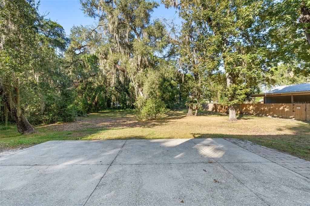 4855 Lillian Black Road St. Cloud, FL 34771 - Photo 50 of 62 a view of yard with swimming pool and trees in the background