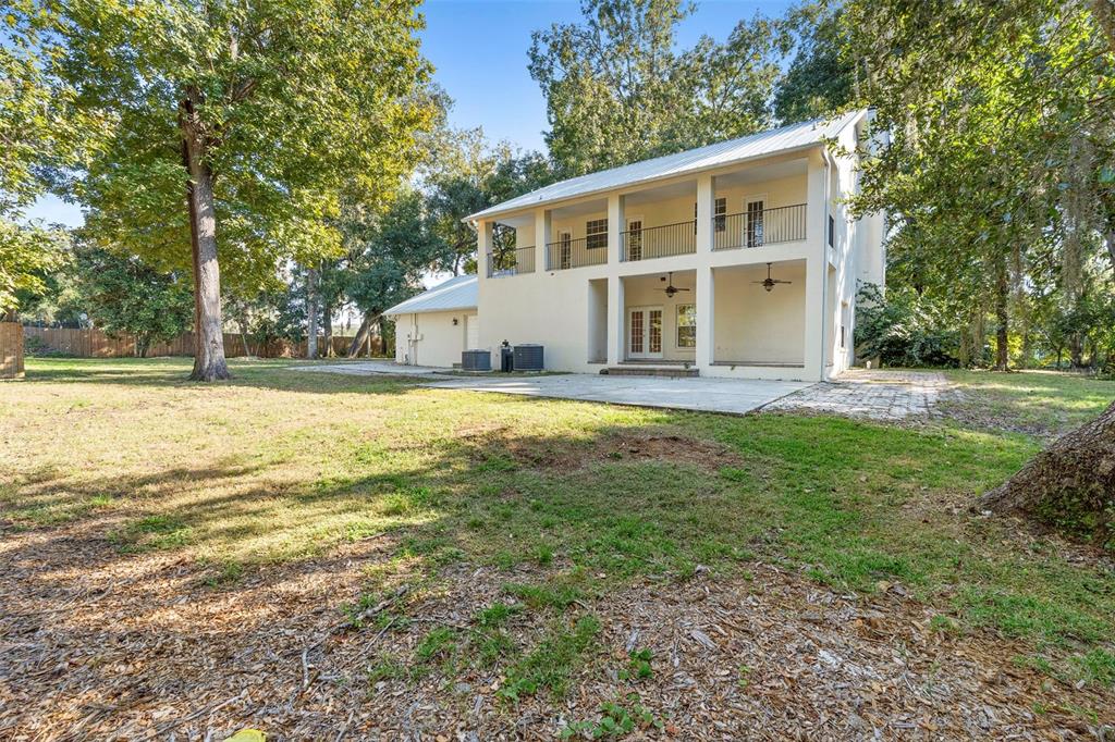4855 Lillian Black Road St. Cloud, FL 34771 - Photo 52 of 62 a view of a house with a big yard and large trees