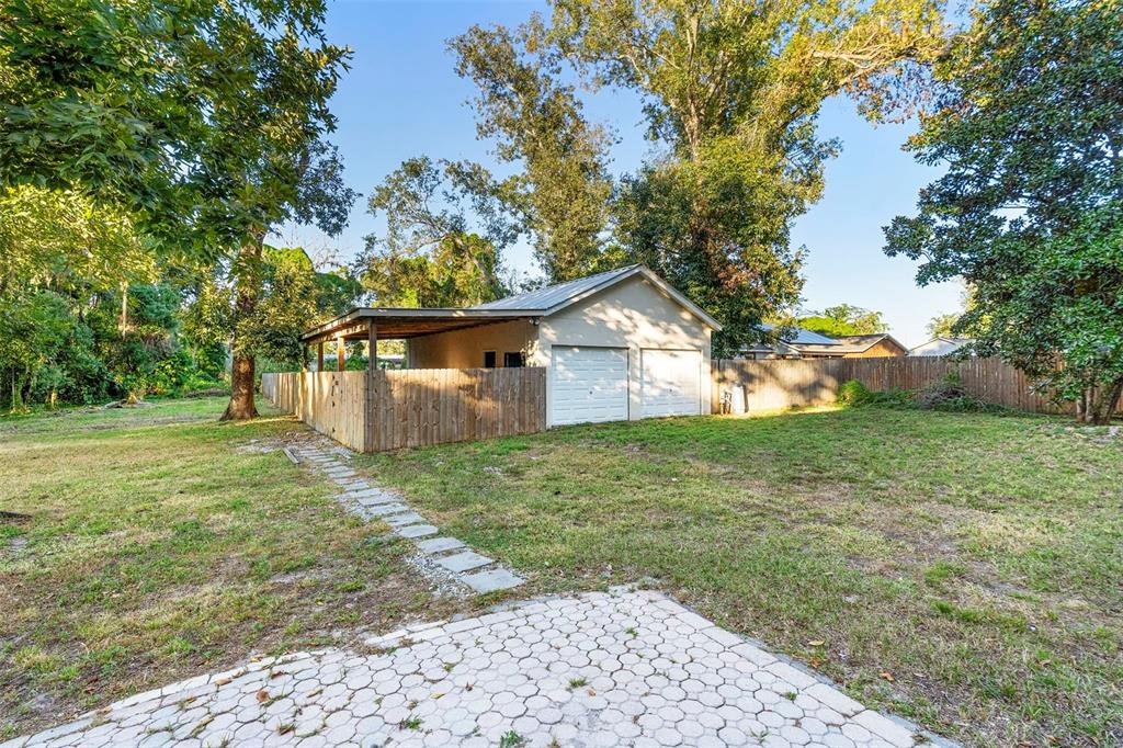 4855 Lillian Black Road St. Cloud, FL 34771 - Photo 54 of 62 a view of a house with yard and a garden