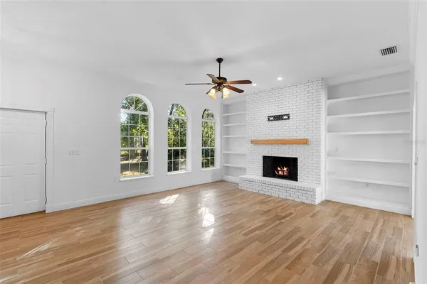 a view of empty room with wooden floor
