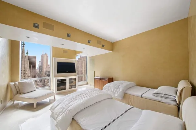 a hotel room with a bed furniture and a flat screen tv