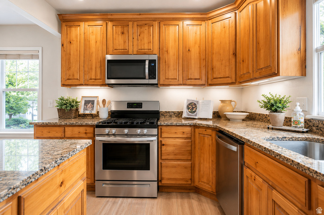 896 Cres Drive South Mapleton, UT 84664 - Photo 10 of 32 Kitchen featuring natural wood cabinetry, stone countertops, stainless steel appliances, and a double basin sink