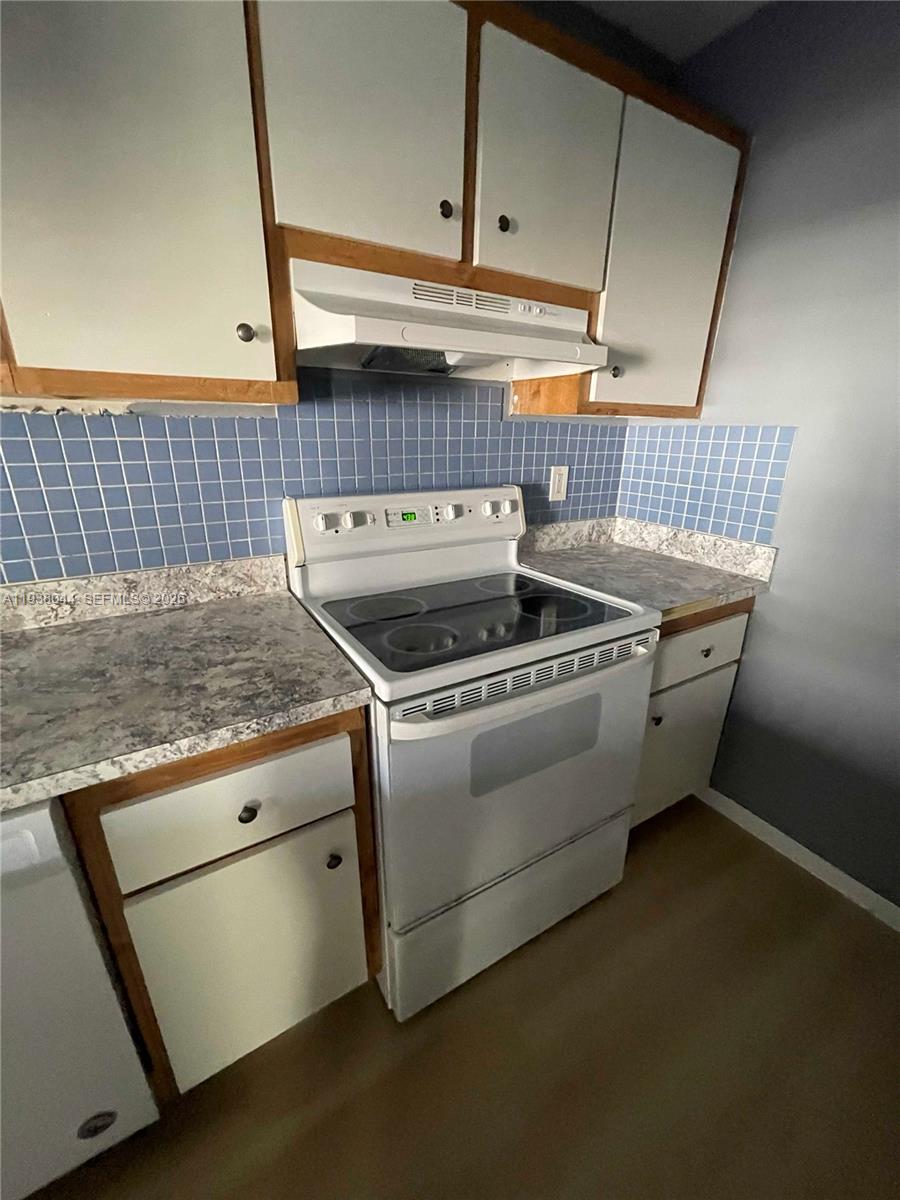 15330 Southwest 72nd Street, Unit 721 Miami, FL 33193 - Photo 4 of 14 a stove top oven sitting inside of a kitchen