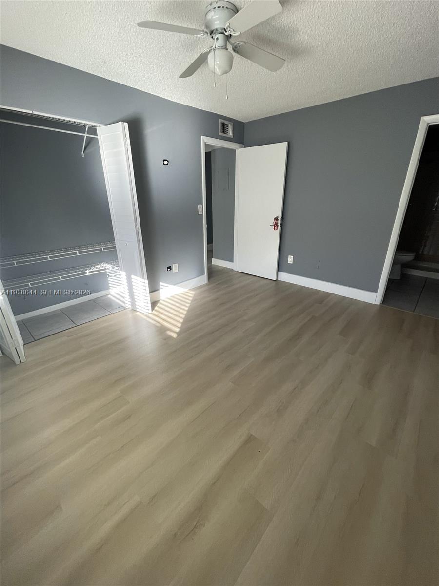15330 Southwest 72nd Street, Unit 721 Miami, FL 33193 - Photo 9 of 14 an empty room with wooden floor and entryway
