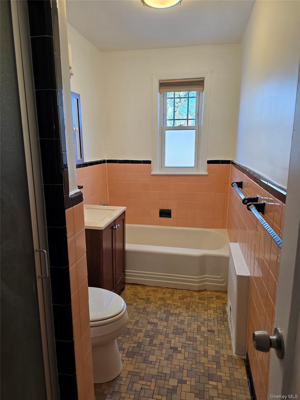 150-25 77th Road Queens, NY 11367 - Photo 3 of 12 a bathroom with a toilet a sink and a bathtub