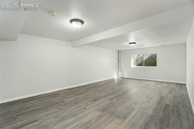 86 Rising Sun Terrace Colorado Springs, CO 80921 - Photo 24 of 36 Empty room with wood finished floors and baseboards