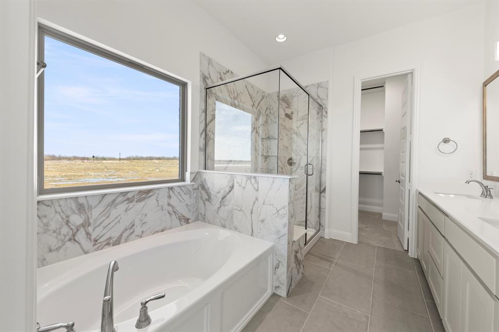 3306 Agnew Street Celina, TX 75009 - Photo 16 of 27 a bathroom with a bathtub and a shower