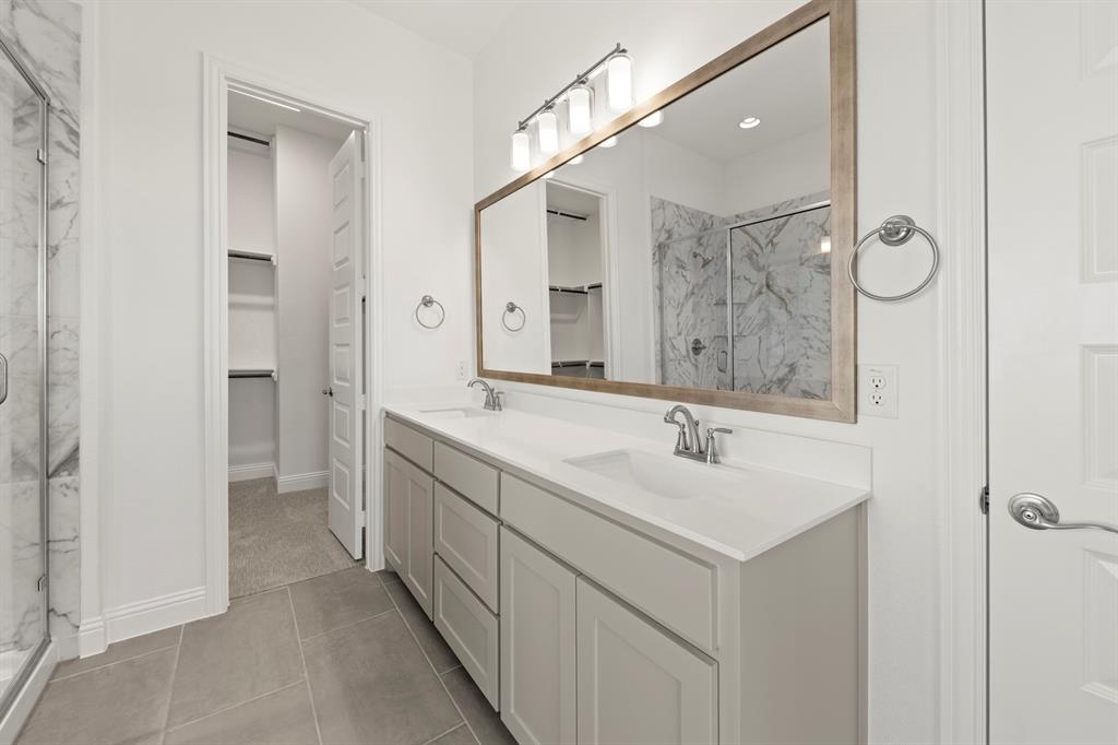 3306 Agnew Street Celina, TX 75009 - Photo 17 of 27 a bathroom with a sink and a mirror