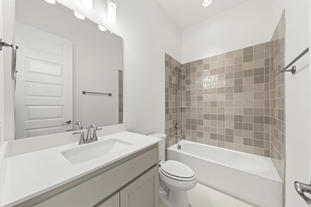 3306 Agnew Street Celina, TX 75009 - Photo 21 of 27 a bathroom with a sink a toilet and bathtub