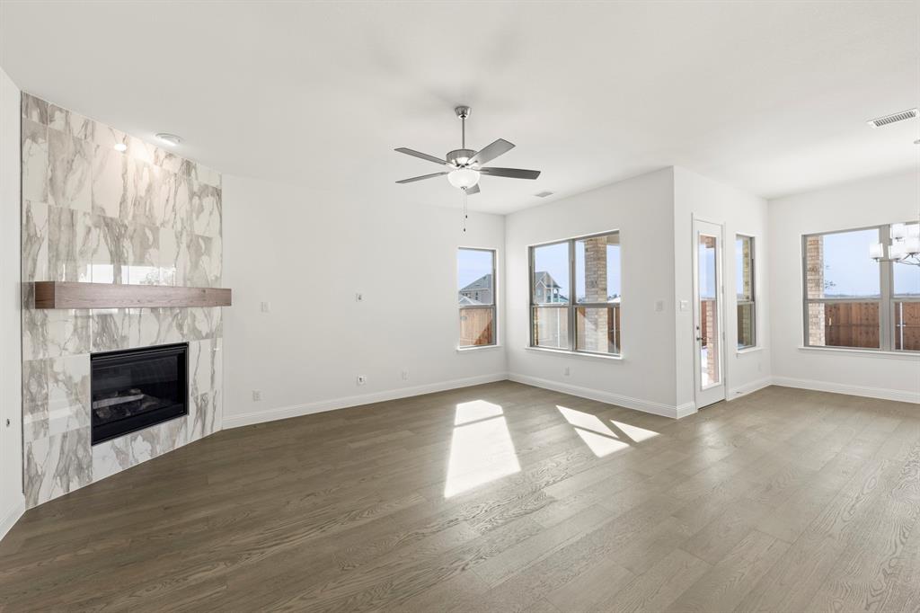 3306 Agnew Street Celina, TX 75009 - Photo 4 of 27 a view of an empty room with chandelier fan and fire place