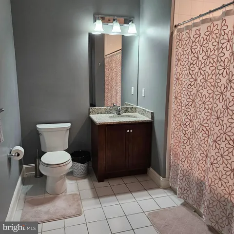 a bathroom with a sink vanity and toilet