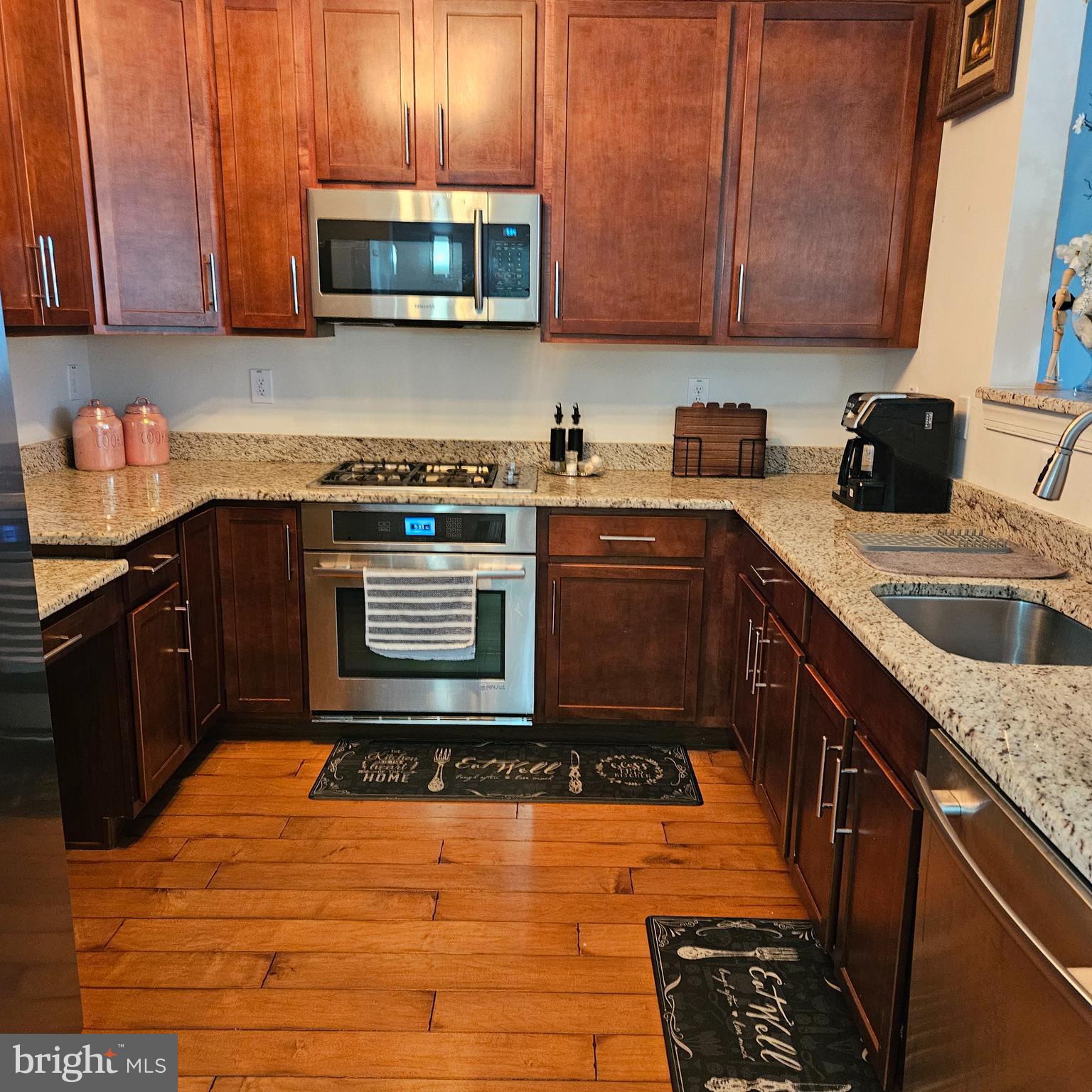 968 Robbinsville Edinburg Road, Unit 305 Robbinsville, NJ 08691 - Photo 8 of 24 a kitchen with stainless steel appliances granite countertop a stove a sink and a microwave