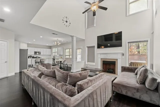 a living room with furniture a flat screen tv and a fireplace